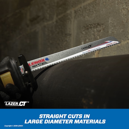LENOX 2014212 carbide-tipped reciprocating saw blade cutting thick metal pipe, close-up side angle.