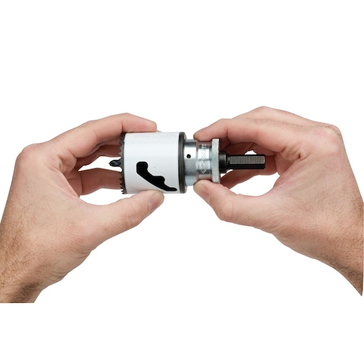 Photo of LENOX hole saw with arbor SKU 1779772 held in hands, white background, close-up view.