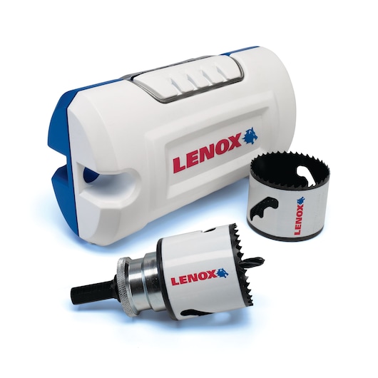 A Lenox hole saw kit is displayed, including a white and blue plastic case and two white hole saws with jagged black cutting edges. The Lenox logo in red and blue is visible on each item.