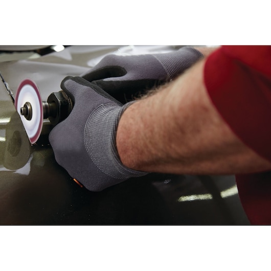 LENOX abrasive disc 1972918 in use on metal surface, worker wearing gray gloves operating power tool.