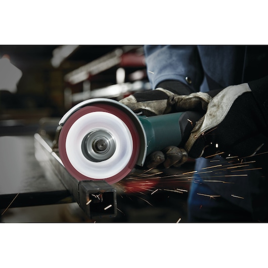 LENOX 1972921 grinding wheel in use on metal, creating sparks, photography of gloved hands holding tool.