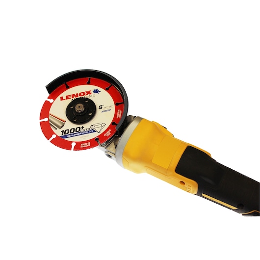 Photo of LENOX 1972922 circular saw blade attached to a yellow angle grinder, white background, top angle.