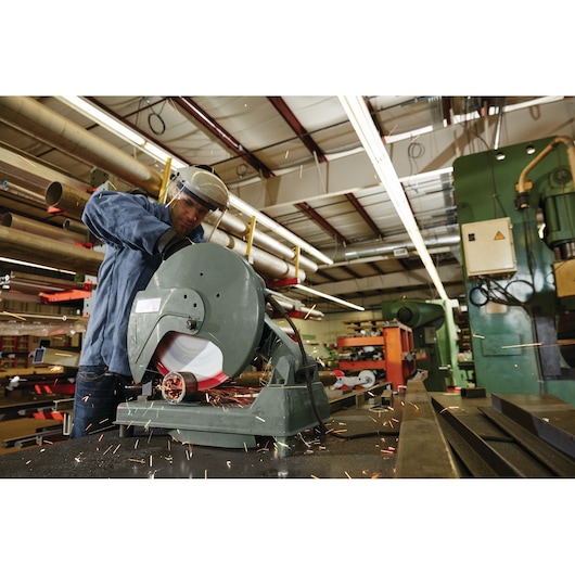 LENOX SKU 1972932 metal cutting wheel in use on chop saw, sparks flying, industrial workshop background.