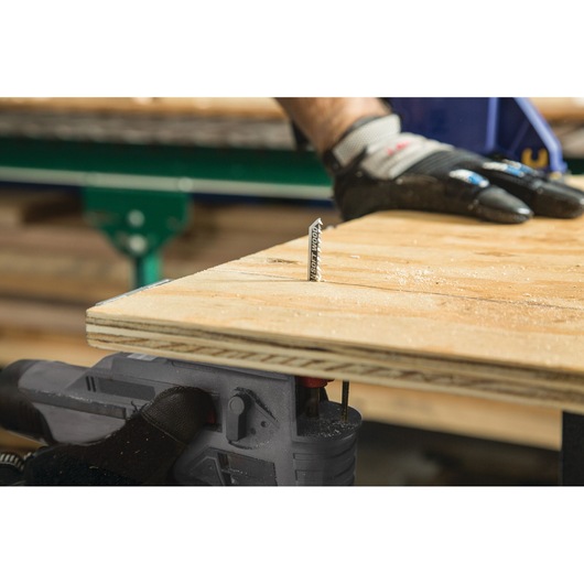 LENOX 1990965 jigsaw blade cutting through plywood, close-up with gloved hand steadying the board.