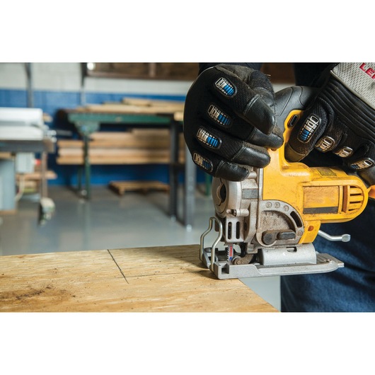 LENOX jigsaw blade SKU 1990965 cutting wood, attached to a yellow jigsaw, worker wearing protective gloves.