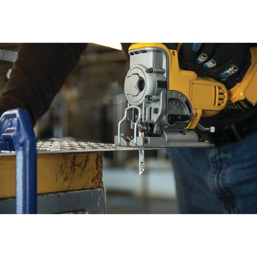 LENOX 1991566 jig saw blade cutting through sheet metal attached to yellow power tool, close-up action shot.