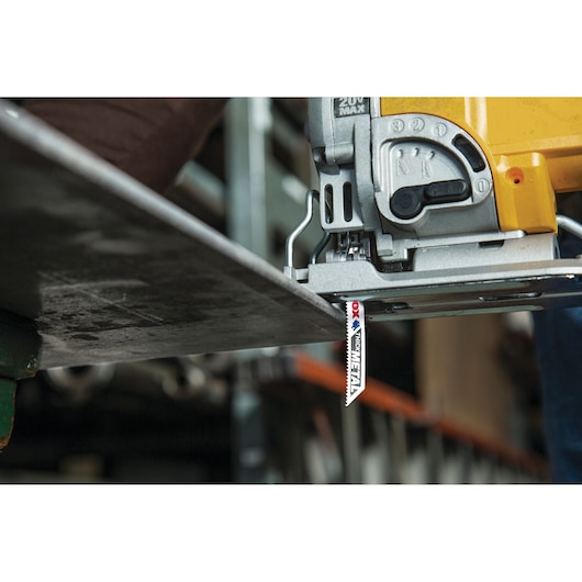 Photo of LENOX 1991596 jigsaw blade cutting through a metal sheet, close-up on the cutting action.