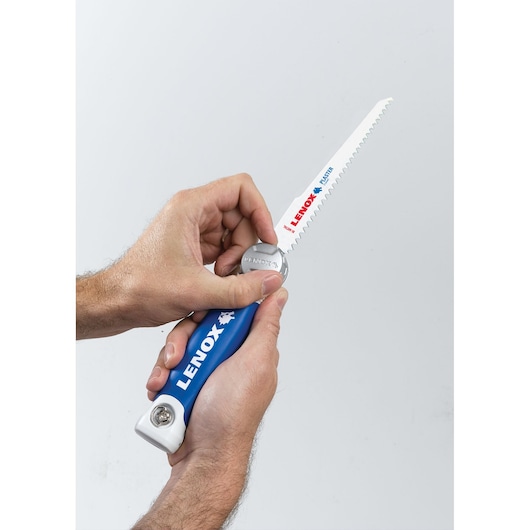 LENOX 20997TFHS618636 folding hand saw with blue handle and exposed blade, held in two hands.