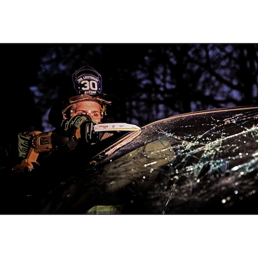 Photo of LENOX 21221B960GR reciprocating saw blade cutting a cracked car windshield during rescue operation.