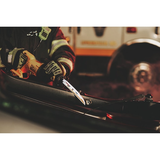 LENOX 21221B960GR reciprocating saw blade cutting through metal pipe, firefighter using tool in rescue operation.