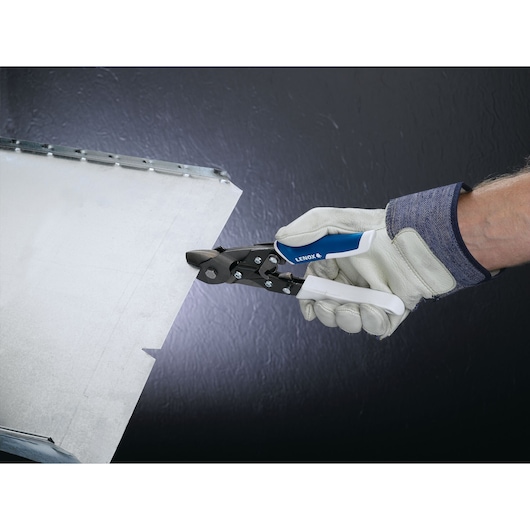 Photo of LENOX 22211N2 aviation snips cutting sheet metal, gloved hand holding tool.