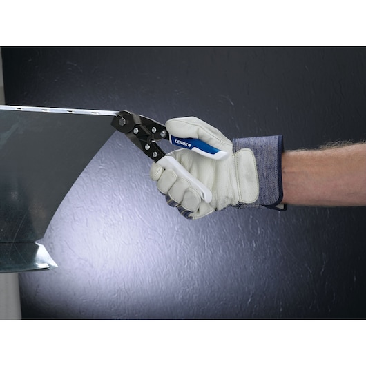Photo of gloved hand cutting sheet metal with LENOX aviation snips 22212SL1.