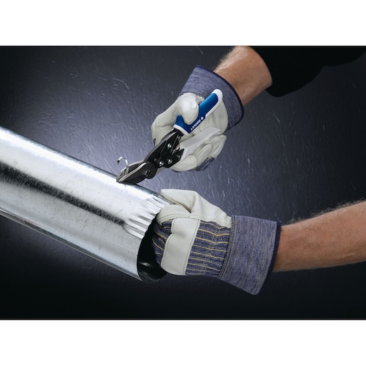 LENOX snips 22213PDC4R cutting metal duct, hands wearing work gloves hold and cut the silver pipe.