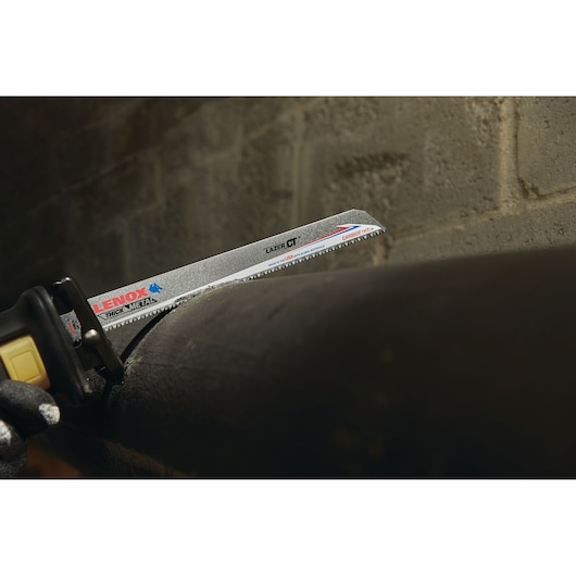 LENOX LXAR12108CT reciprocating saw blade cutting thick metal pipe in close-up photography.