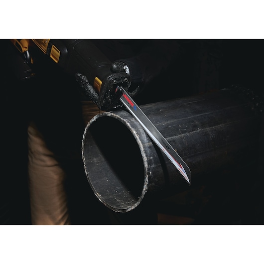 LENOX LXAR12110CT-1 reciprocating saw blade cutting through large black metal pipe.