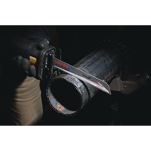LENOX LXAR9110CT-1 metal cutting saw blade in use cutting a large metal pipe, close-up view.