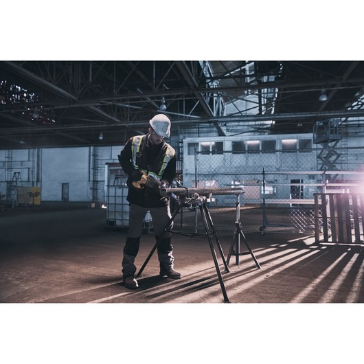 Photo of a worker using a LENOX pipe cutting tool LXAR9110CT-1 in an industrial warehouse setting.