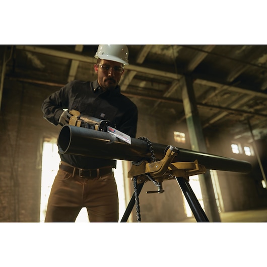 LENOX LXAR9110CT-1 reciprocating saw blade cutting through large black metal pipe on jobsite.