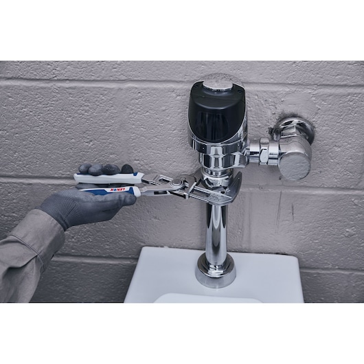 Photo of LENOX LXHT90540 groove joint pliers being used to adjust chrome plumbing fixture.