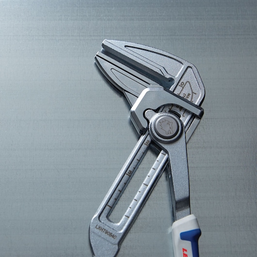Photo of LENOX adjustable wrench LXHT90540 with silver finish and measurement markings on metallic surface.