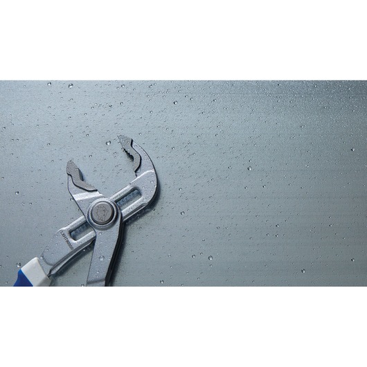 LENOX LXHT90550 groove joint pliers with blue handle on wet metallic surface, left side view.