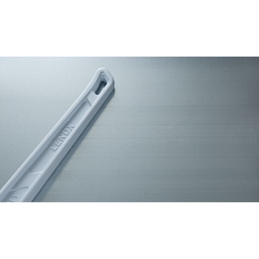 Photo of LENOX LXHT90718 hand tool partial view on metallic surface, white background, angled top left.