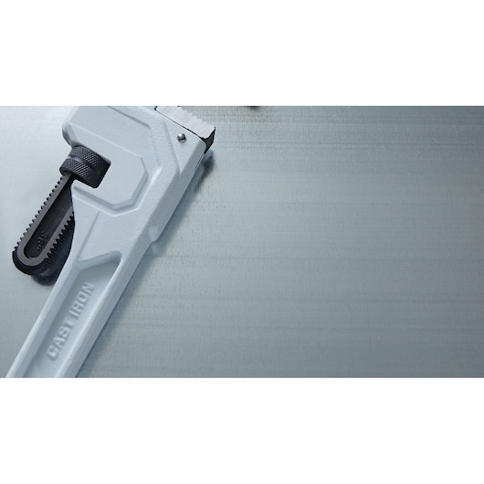 LENOX LXHT90736 silver cast iron pipe wrench close-up on metallic surface, partial view.
